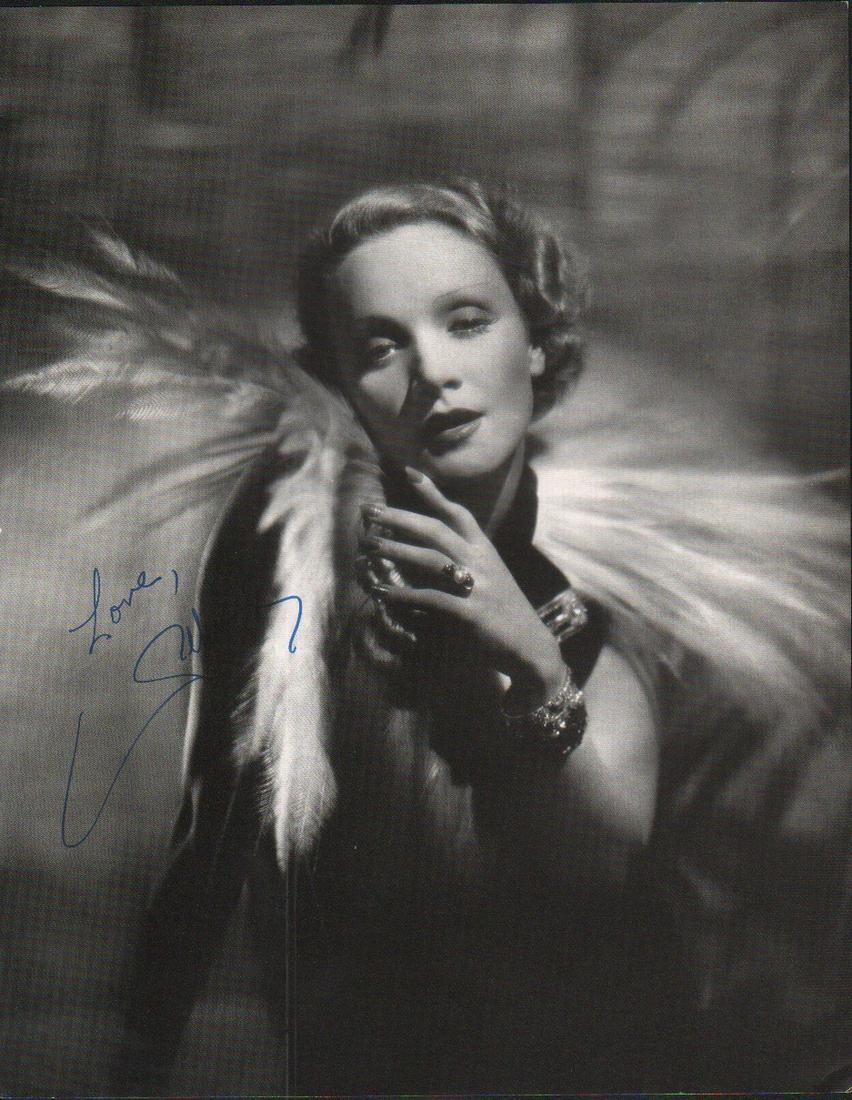 Marlene Dietrich signed photograph: A killer larger 9x12 photo taken from a coffee table book and signed in person to a man who was the newspaper interviewer for entertainment for San Francisco paper for 50 years with COA