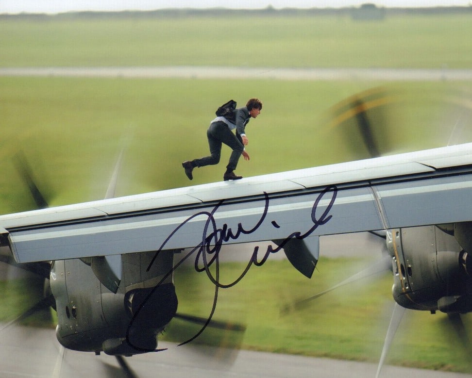 Tom Cruise signed photograph: Killer shot from recent Mission Impossible film signed by him doing one of his crazy stunts This item comes with a fully illustrated serial numbered letter of authenticity guaranteeing its authenticit