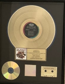 The Beatles RIAA record award presented to THEM