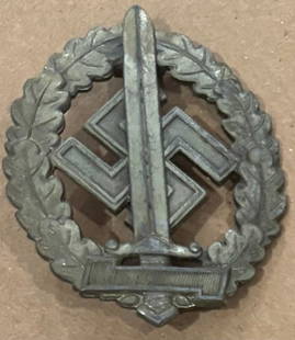 German Nazi pin: Large approx 3 inches long war wounded silver badge showing sword and swastika in a wreath