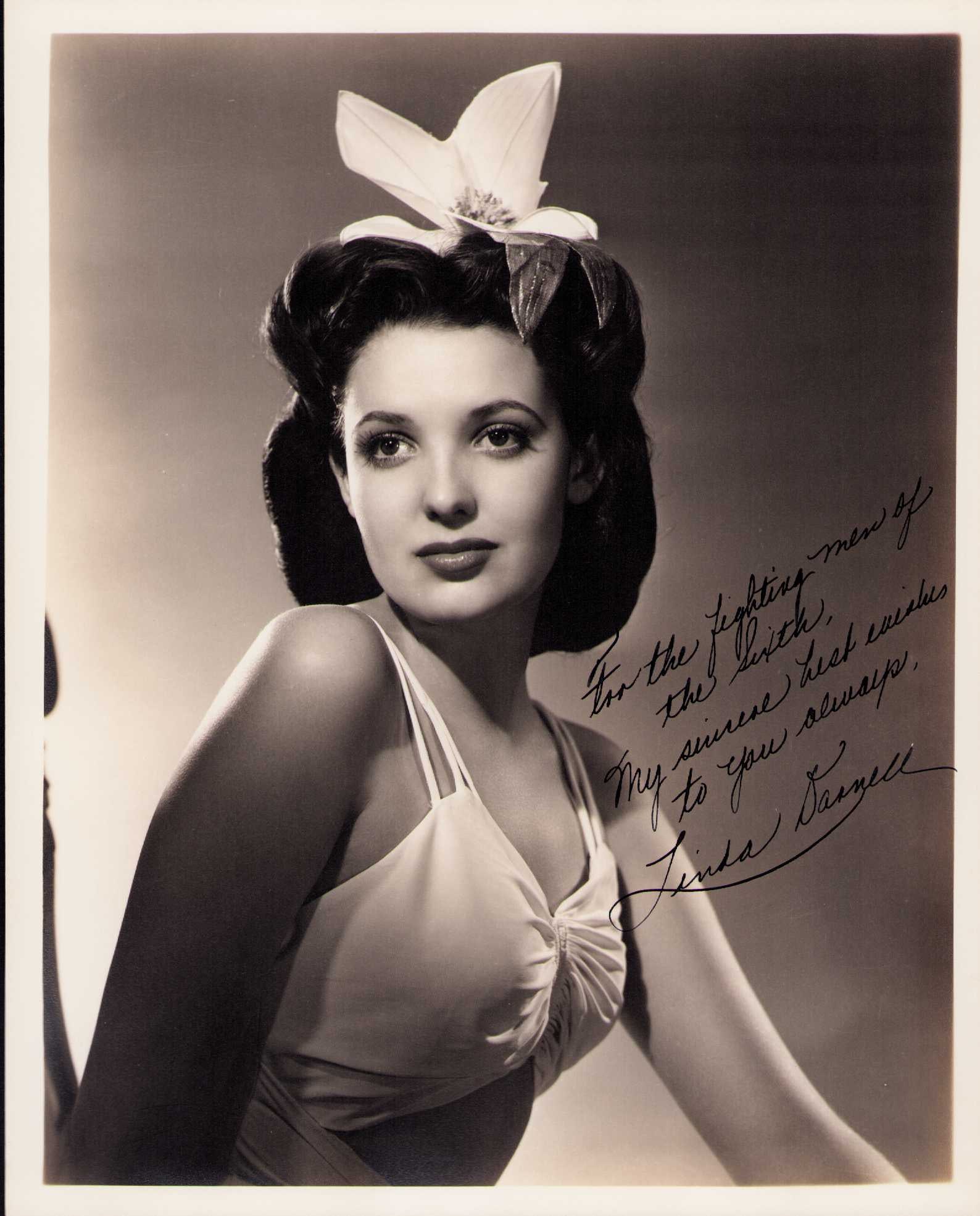 Linda Darnell signed photograph: A sexy 1940s rare signed sepia toned heavyweight 8x10 to a group of military men signed at a WWII war drive event Certificate of AuthenticityEVERY item in this auction comes with at minimum a fully il