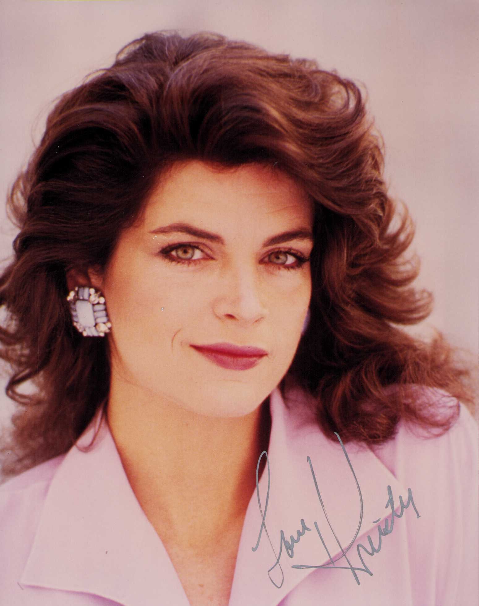 Kirstie Alley signed photograph: A scarce vintage signed 8x10 by deceased actress from Cheers and other series Certificate of AuthenticityEVERY item in this auction comes with at minimum a fully illustrated and serial numbered COA si
