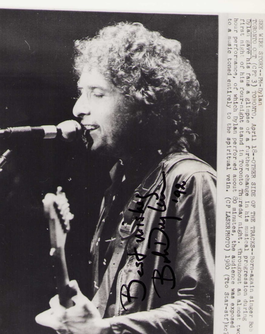 Bob Dylan signed photograph: A rare original wire photo of the legend and poet laureate signed and dated in 1992 Certificate of AuthenticityEVERY item in this auction comes with at minimum a fully illustrated and serial numbered