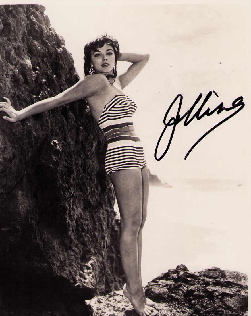 Joan Collins signed photograph: An original sexy cheesecake still of a 19 year old Collins signed later in life Certificate of AuthenticityEVERY item in this auction comes with at minimum a fully illustrated and serial numbered