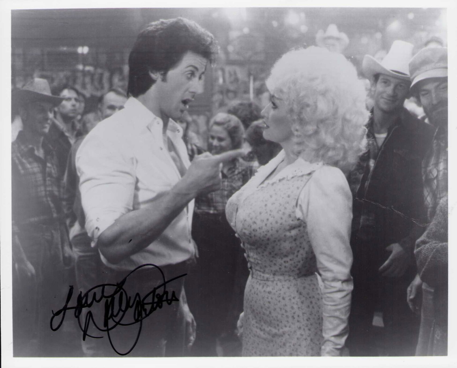Dolly Parton signed photograph: A vintage original still from the Stallone film Rhinestone signed by her Certificate of AuthenticityEVERY item in this auction comes with at minimum one fully illustrated and serial numbered COA signe