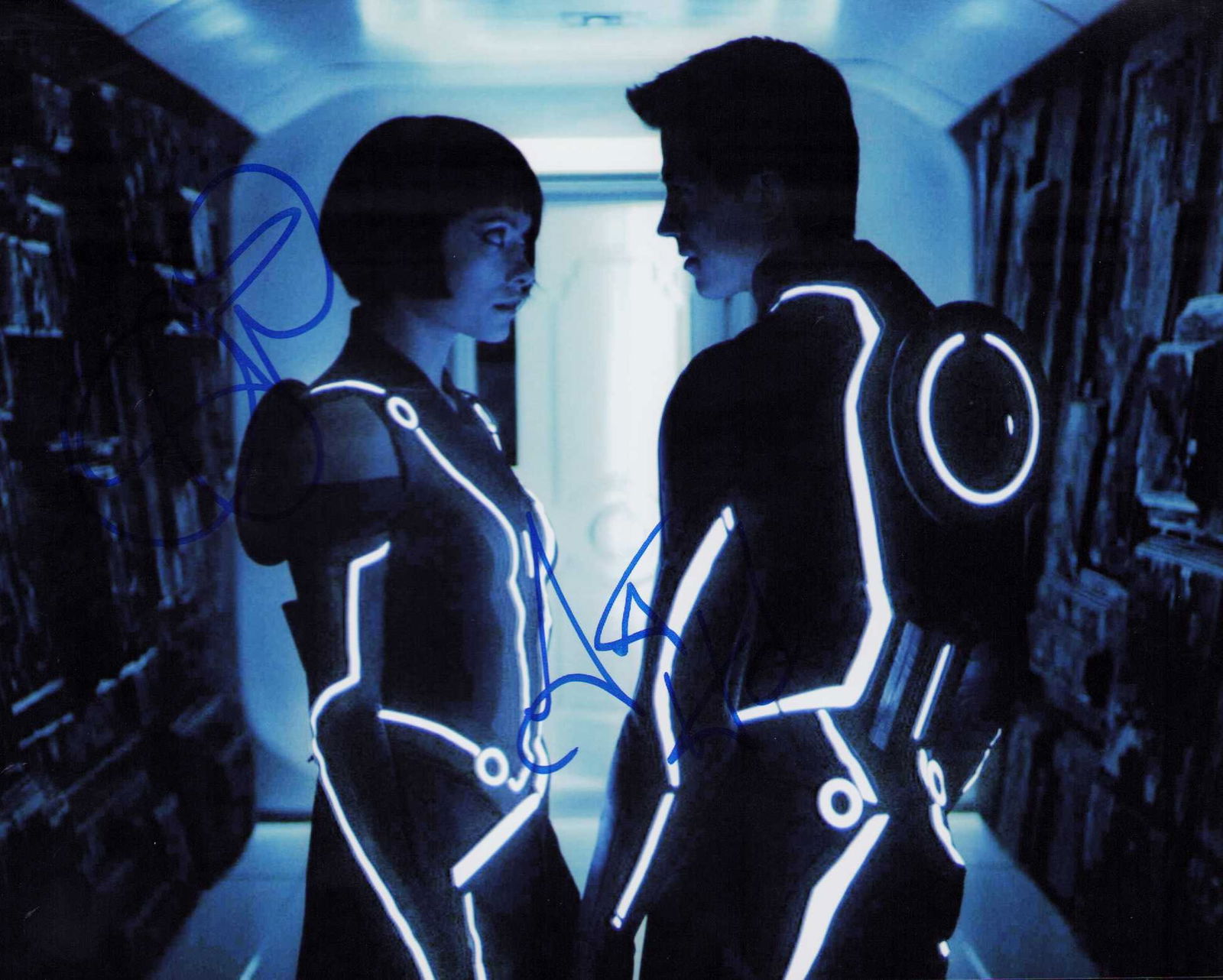 Tron Legacy cast signed photograph: Signed by Garret Hedlund and Olivia Wilde in character from the film Certificate of AuthenticityEVERY item in this auction comes with at minimum one fully illustrated and serial numbered COA signed