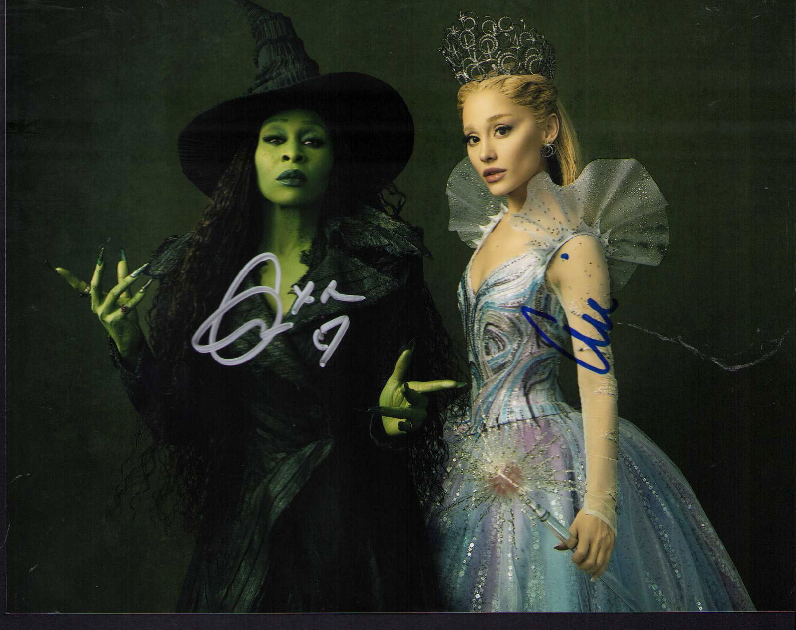Wicked cast signed photograph: Wicked cast signed by Ariana Grande and Cynthia Erivo Certificate of AuthenticityEVERY item in this auction comes with at minimum one fully illustrated and serial numbered COA signed by the worlds lea