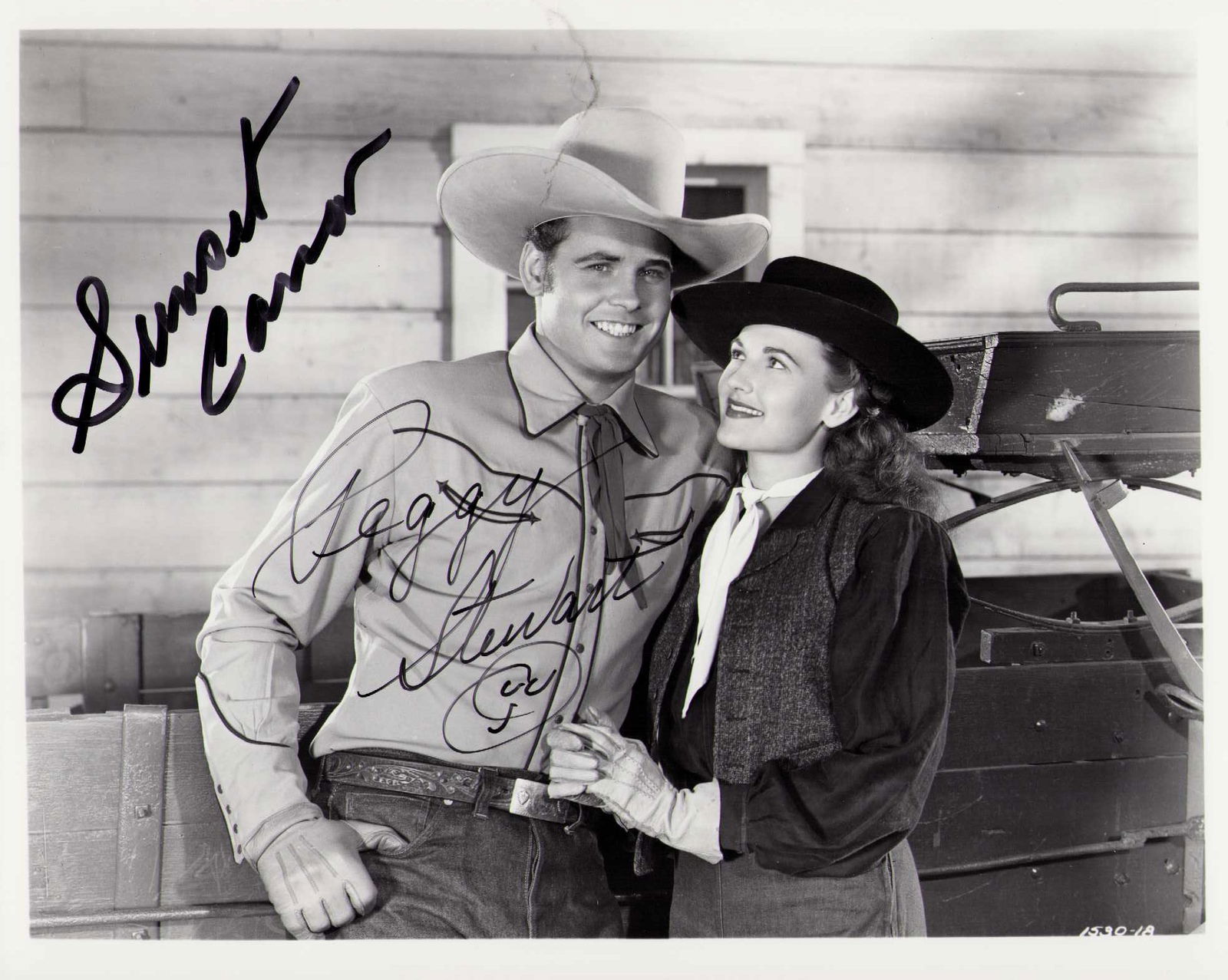 Sunset Carson and Peggy Stewart signed photograph: A Sunset Carson and Peggy Stewart signed western film still by both stars Certificate of AuthenticityEVERY item in this auction comes with at minimum one fully illustrated and serial numbered COA sign