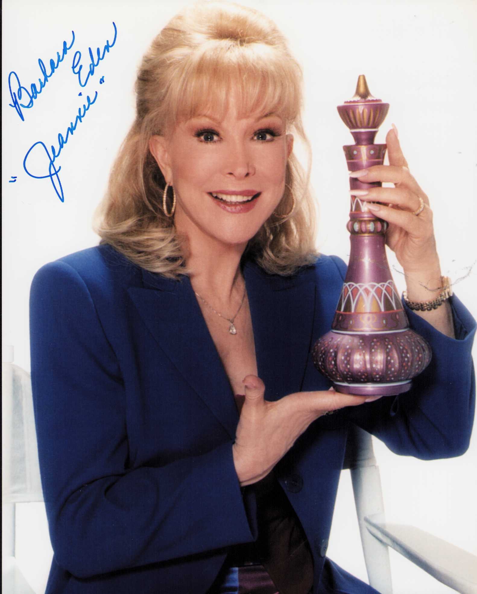 Barbara Eden signed photograph: A vintage signed in later years after the show I Dream of Jeannie shot of her holding a prop bottle Certificate of AuthenticityEVERY item in this auction comes with at minimum one fully illustrated