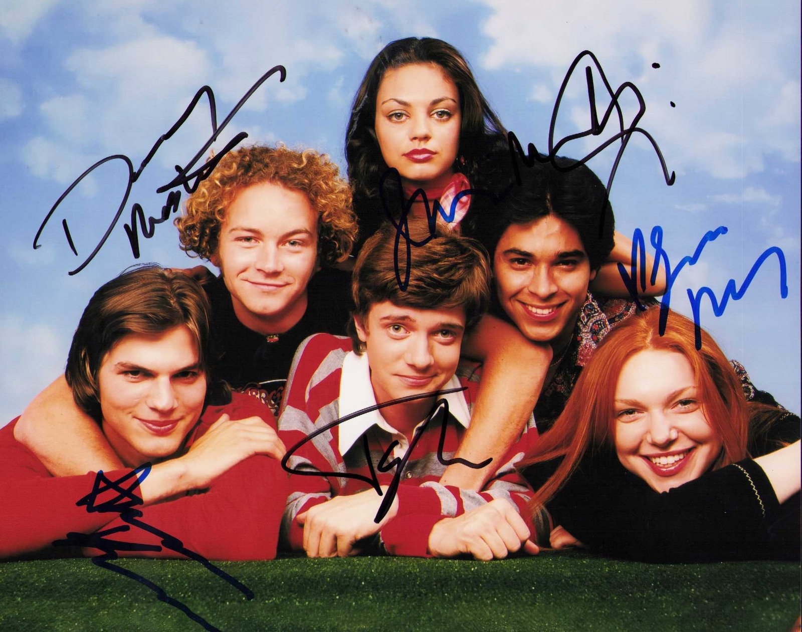 That Seventies Show cast signed photograph: A vintage cast signed 8x10 by all the cast Ashton Kutcher Mila Kunis Laura Prepon Wilmer Valderama Topher Grace and Danny Masterson Certificate of AuthenticityEVERY item in this auction comes with at