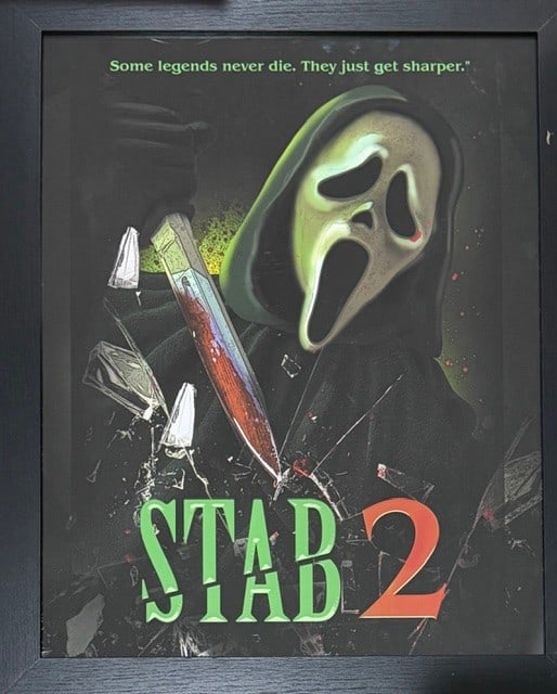 Scream 7 framed art seen on screen in macher house: A framed STAB poster seen on screen and used in the film Scream 7 acquired from an auction of set pieces for cast and crew at the films finish Certificate of AuthenticityEVERY item in this auction com