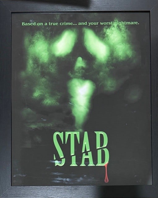 Scream 7 framed art seen on screen in macher house: A framed STAB poster seen on screen and used in the film Scream 7 acquired from an auction of set pieces for cast and crew at the films finish Certificate of AuthenticityEVERY item in this auction