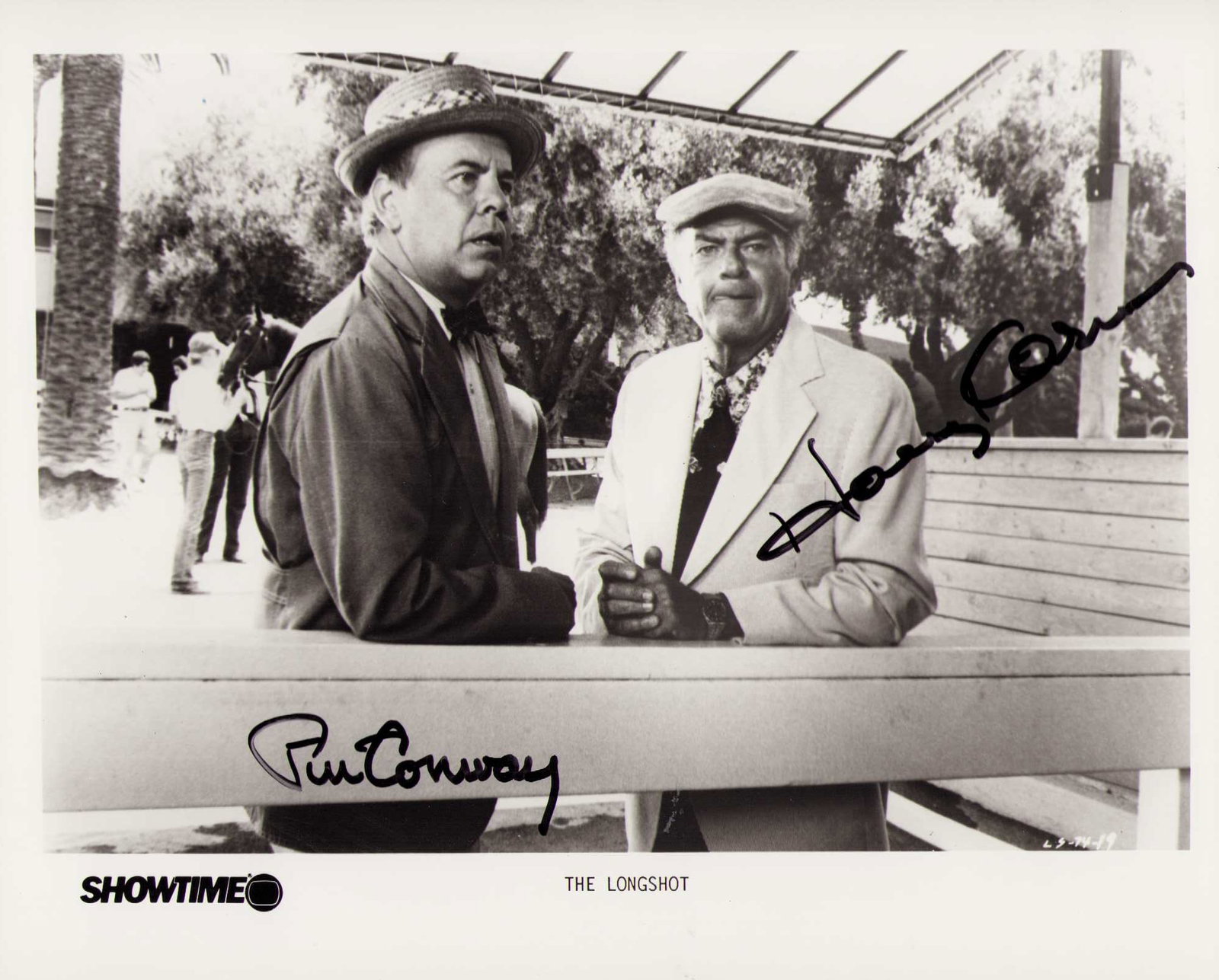 Longshot cast signed Korman and Conway: A vintage scene still from funny film signed by Tim Conway and Harvey Korman Certificate of AuthenticityEVERY item in this auction comes with at minimum one fully illustrated and serial numbered COA s
