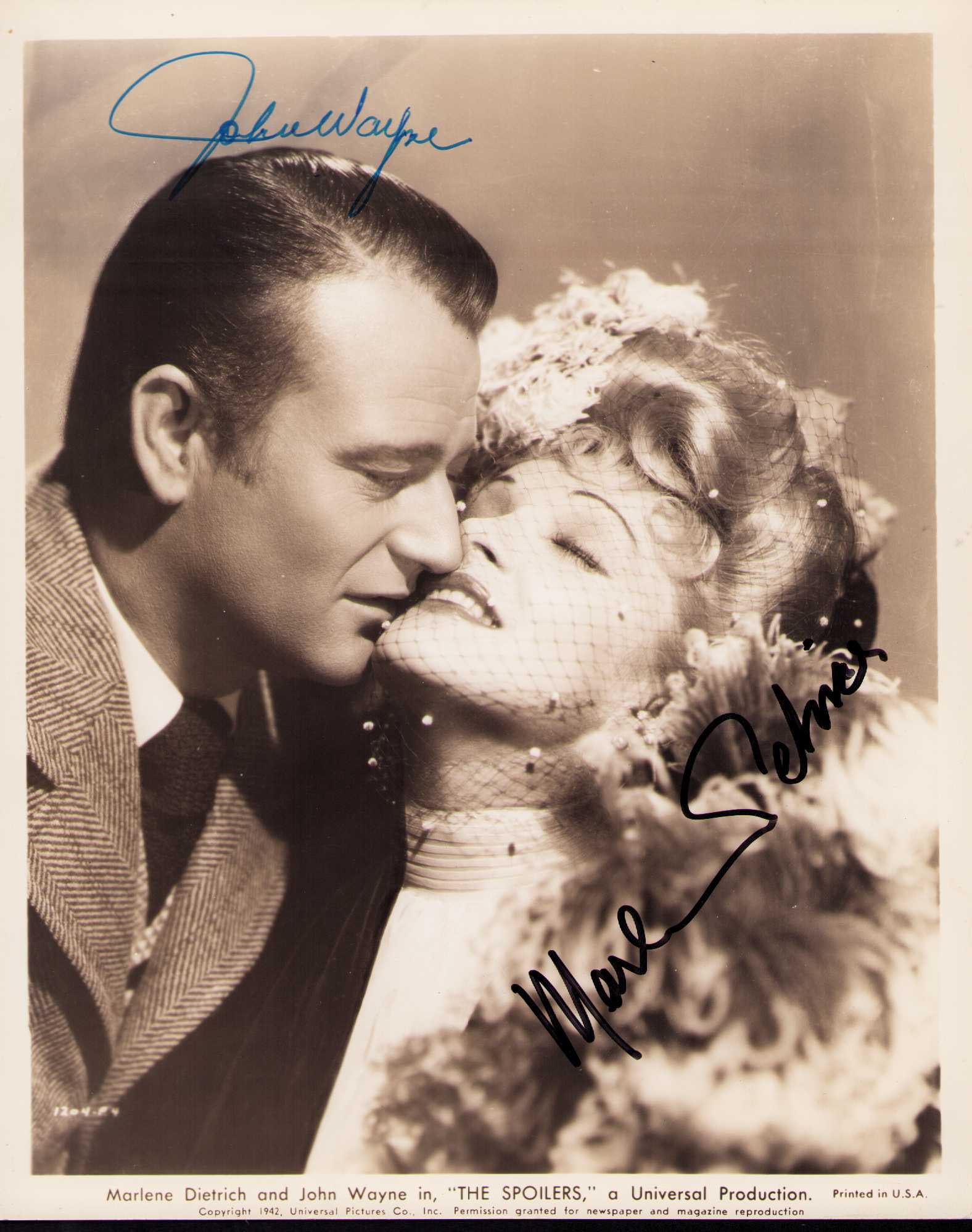 John Wayne and Marlene Dietrich signed photograph: An original 1942 sepia toned still signed by John Wayne and later by Marlene Dietrich both RARE and likely one of a kind Certificate of AuthenticityEVERY item in this auction comes with at minimum one