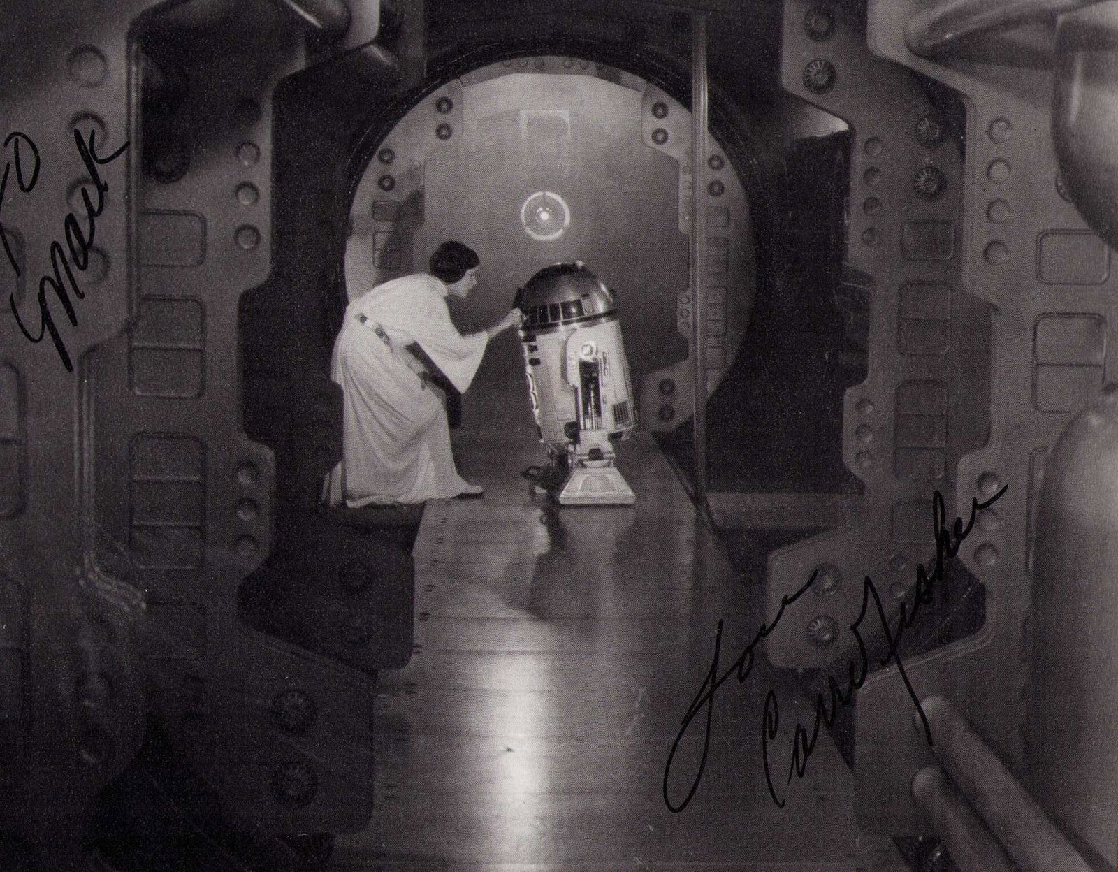 Carrie Fisher signed Star Wars photograph: A VINTAGE signed Star Wars classic scene by Carrie Fisher signed near the time of the film Certificate of AuthenticityEVERY item in this auction comes with at minimum one fully illustrated and serial