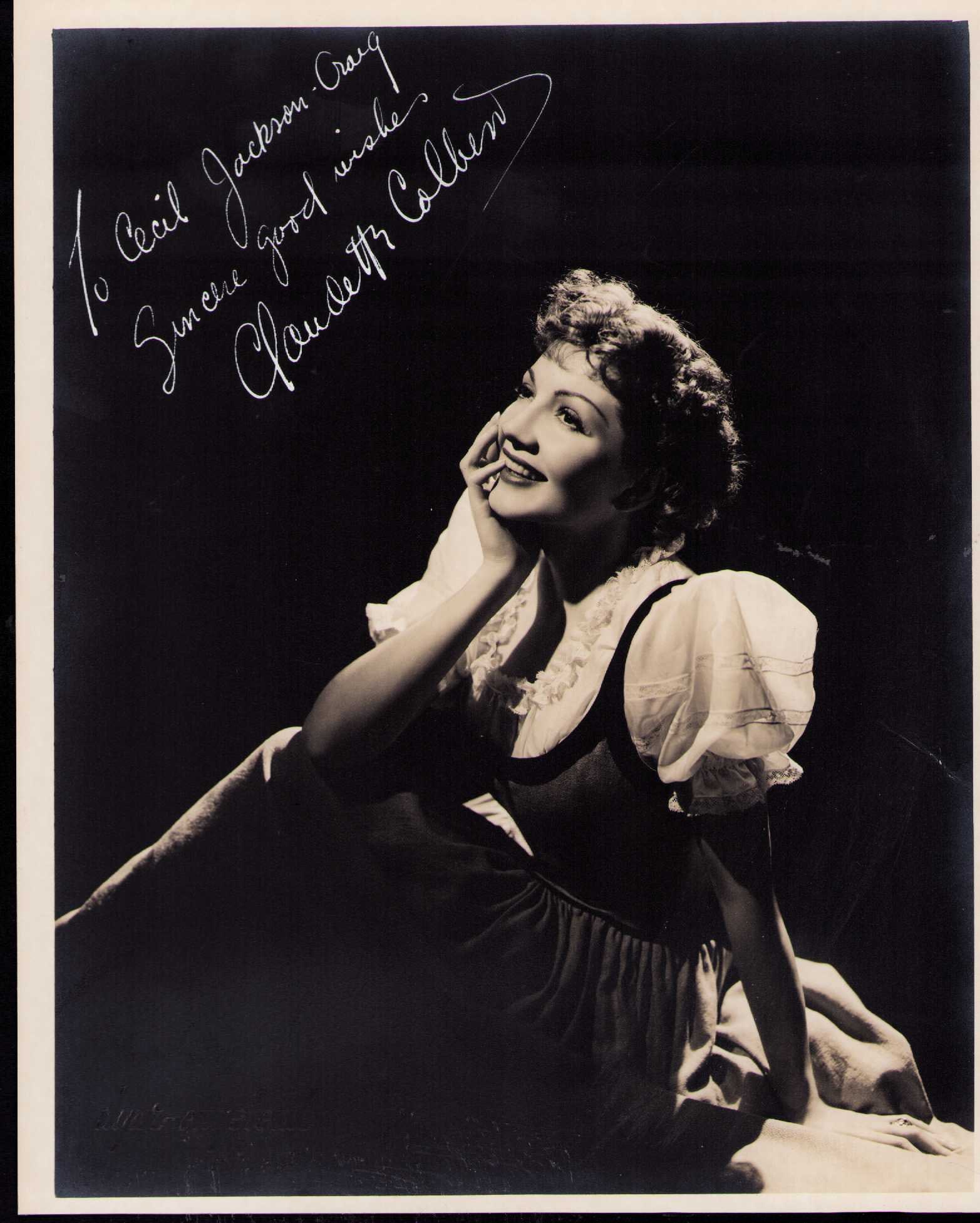 Claudette Colbert early signed photograph: A GORGEOUS early 1930s shot signed in white paint pen ink by her Certificate of AuthenticityEVERY item in this auction comes with at minimum one fully illustrated and serial numbered COA signed by the
