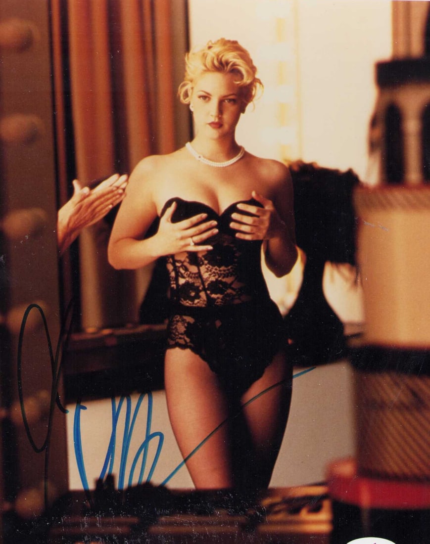 Drew Barrymore signed photograph PSA DNA: A PSA DNA stickered sexy vintage 8x10 of the legendary actress Certificate of AuthenticityEVERY item in this auction comes with at minimum one fully illustrated and serial numbered COA signed by the w