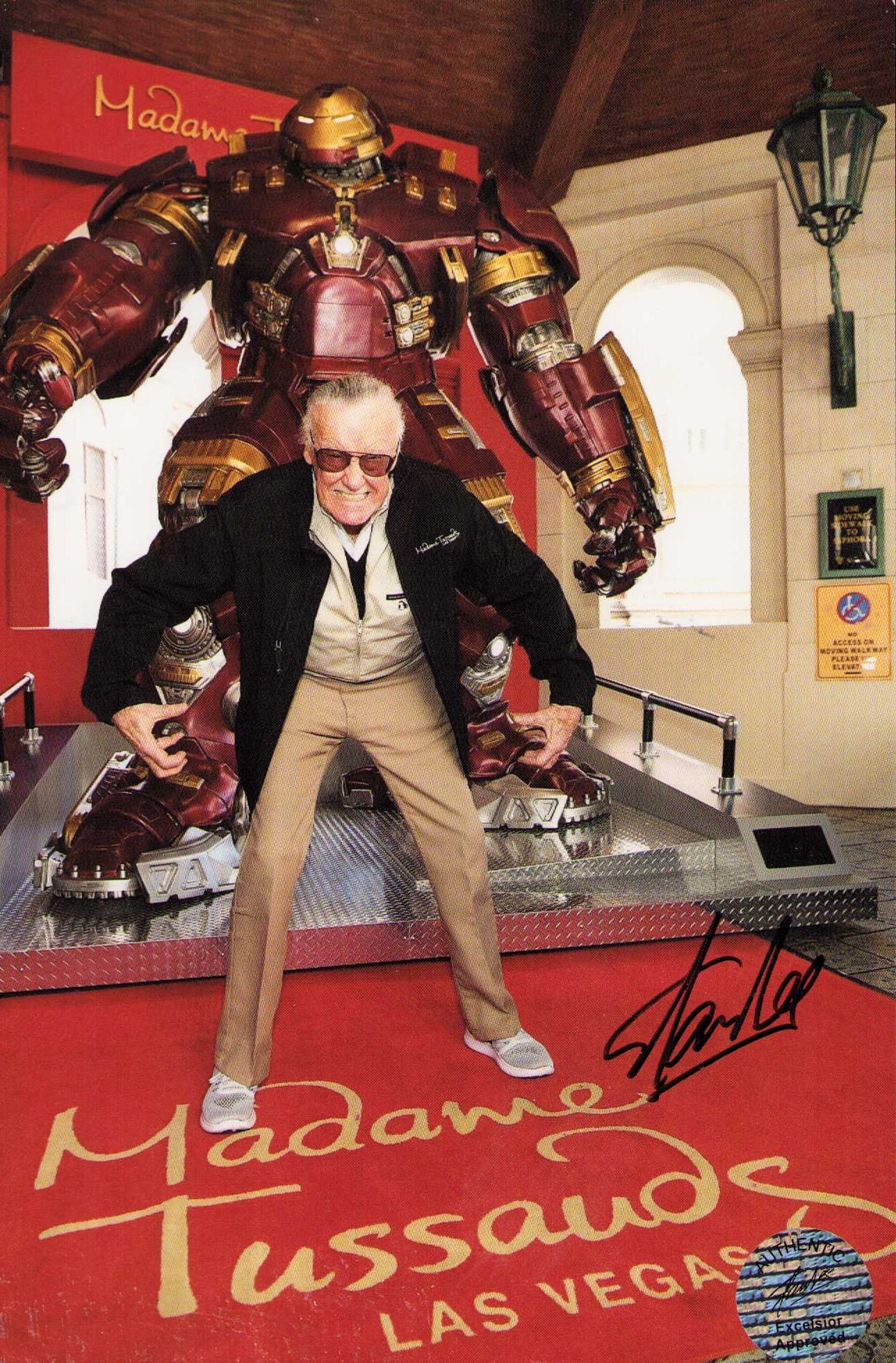 Stan Lee signed photograph: A signed 7x9 photograph with his own hologram on it posing at Madam Tusseuds with an iron Man statue Certificate of AuthenticityEVERY item in this auction comes with at minimum one fully illustrated