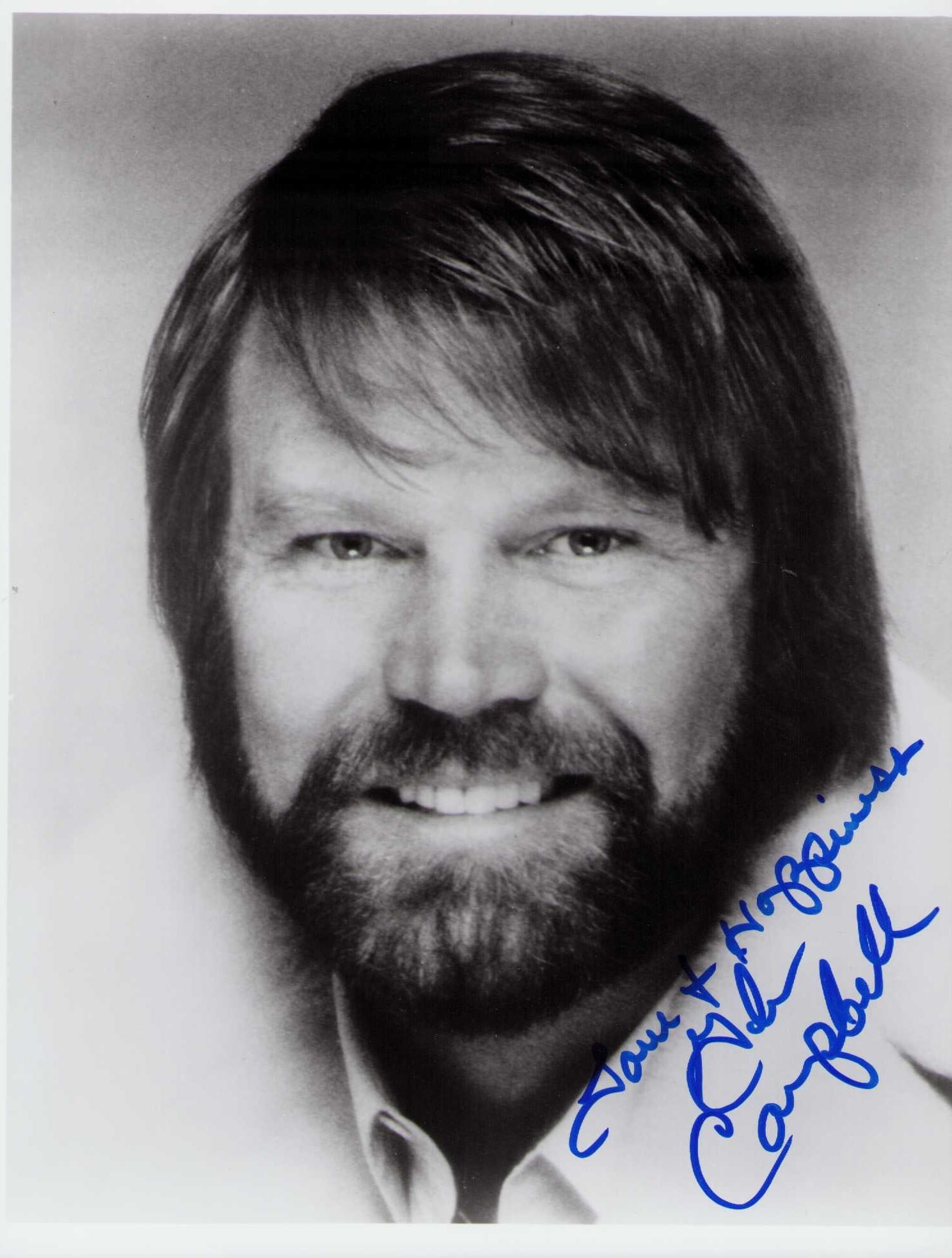Glen Campbell signed photograph: A nice vintage signed 8x10 of the deceased country legend and Rhinestone Cowboy Certificate of AuthenticityEVERY item in this auction comes with at minimum one fully illustrated and serial numbered CO