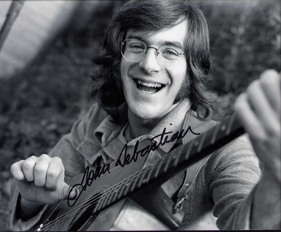John Sebastian signed photograph: Famed singer songwriter currently 82 years old a shot at Woodstock ! Certificate of AuthenticityEVERY item in this auction comes with at minimum one fully illustrated and serial numbered COA signed