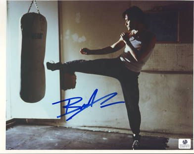 Brandon Lee Signed 8x10 Photograph: The son of the famed martial artist Bruce Lee, Brandon Lee has signed this kick-boxing posed photo from the film "Rapid Fire" in blue ink. Brandon suffered an unfortunate accident and was killed on