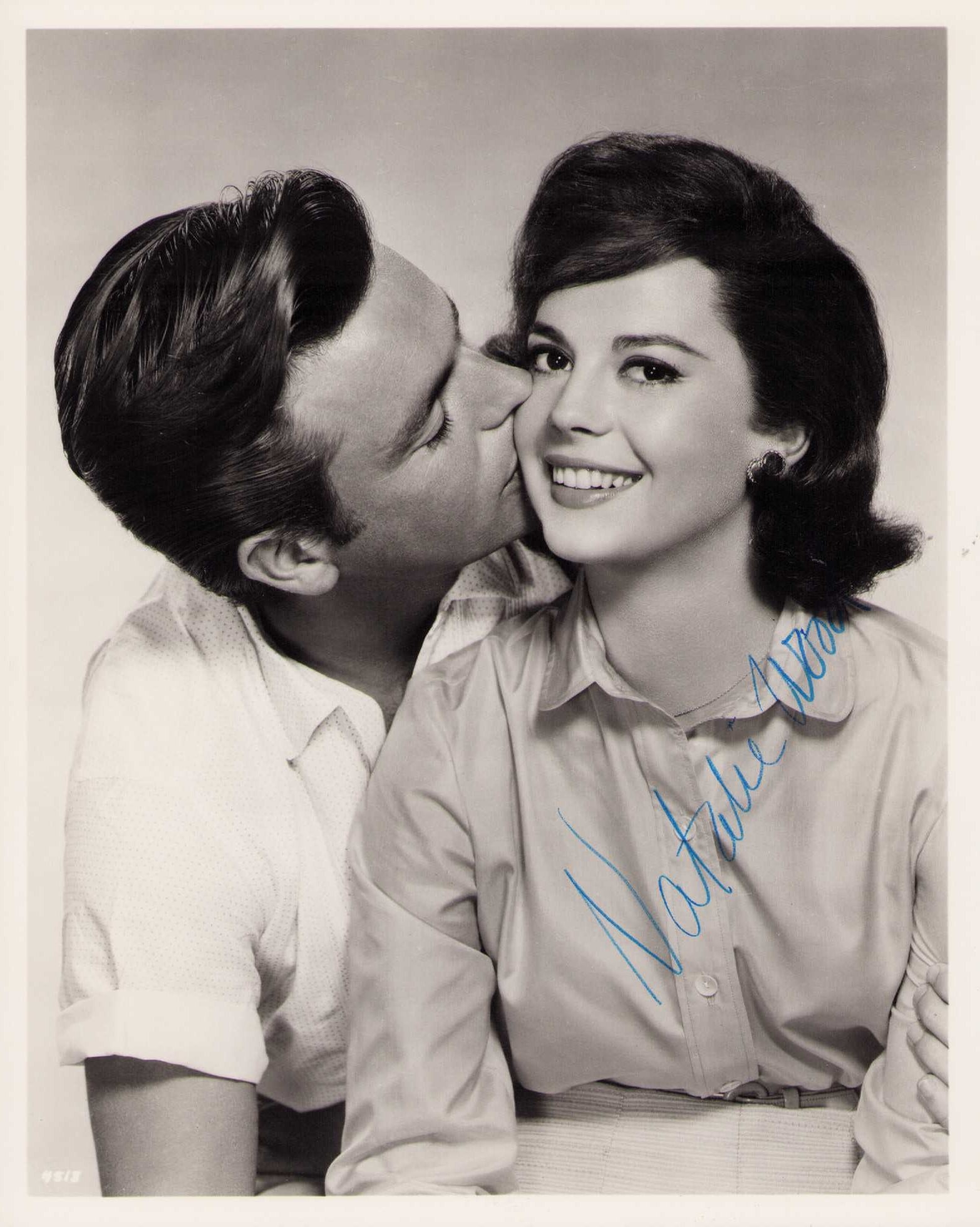 Natalie Wood signed photograph: A heavyweight vintage gorgeous signed 8x10 being kissed by husband Robert Wagner Certificate of AuthenticityEVERY item in this auction comes with at minimum one fully illustrated and serial numbered s