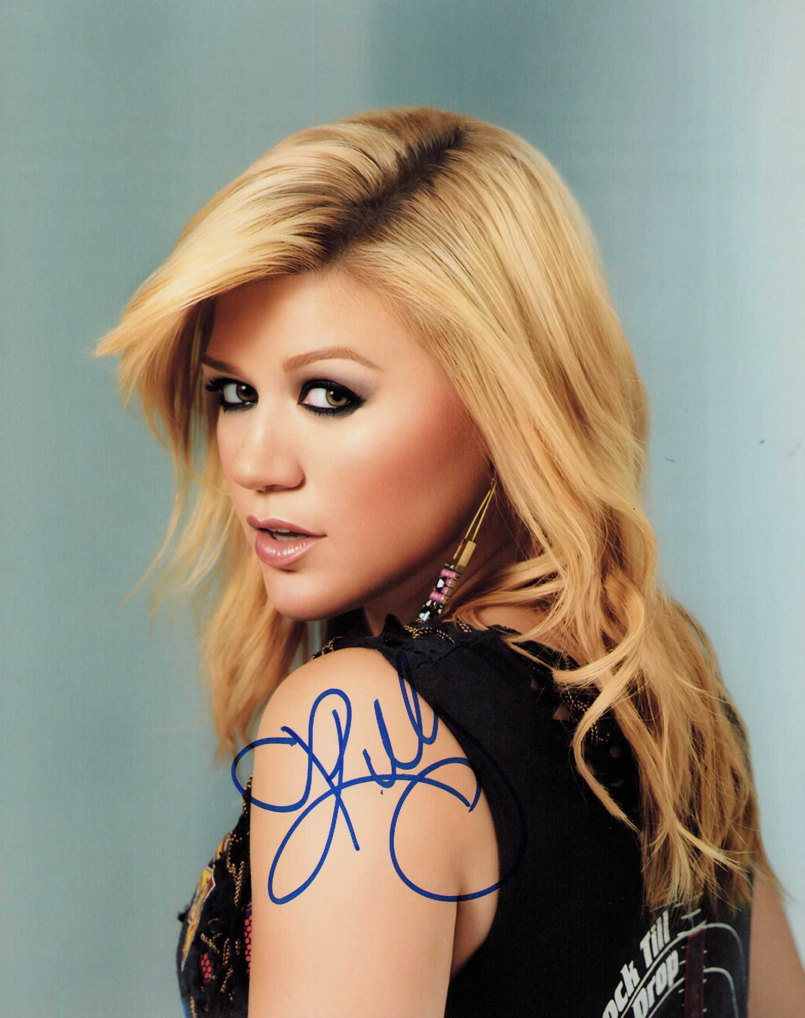 Kelly Clarkson signed photograph: Signed by the incredible singer past Idol winner and now Voice judge and talk show host ! Certificate of AuthenticityEVERY item in this auction comes with at minimum one fully illustrated and serial n