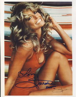 Farrah Fawcett Signed 8x10 Bathing Suit Photograph: This is an 8x10 photograph signed by Farrah Fawcett wearing the red bathing suit from the infamous poster taken during her run in the television series "Charlie's Angels". She has signed it "Love