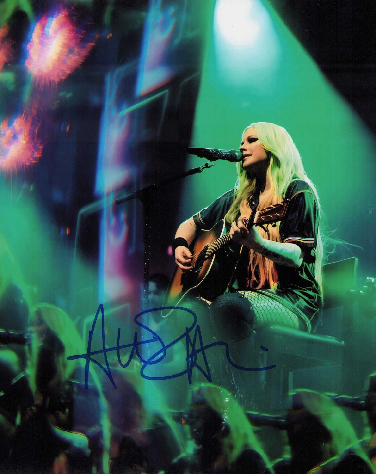 Avril Lavigne signed photograph: A sexy signed 8x10 of the Singer Certificate of AuthenticityEVERY item in this auction comes with at minimum one fully illustrated and serial numbered searchable online COA signed by the leading