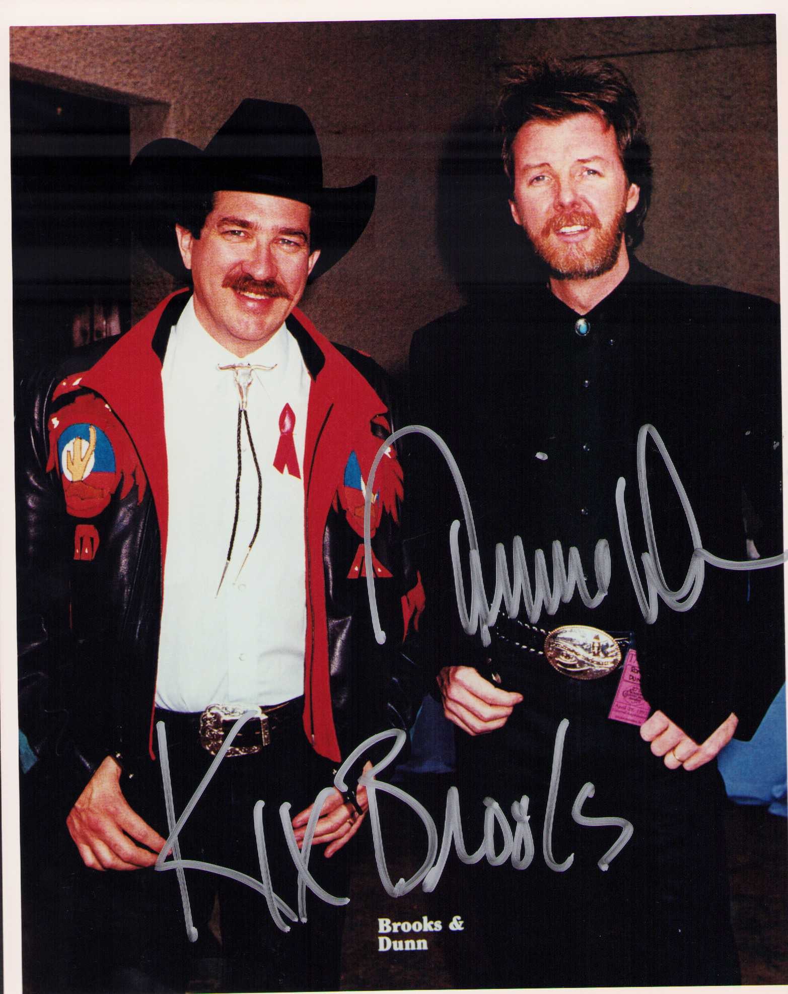 Brooks and Dunn signed photograph: A signed 8x10 by both of the famed country duo Certificate of AuthenticityEVERY item in this auction comes with at minimum one fully illustrated and serial numbered searchable online COA signed by the
