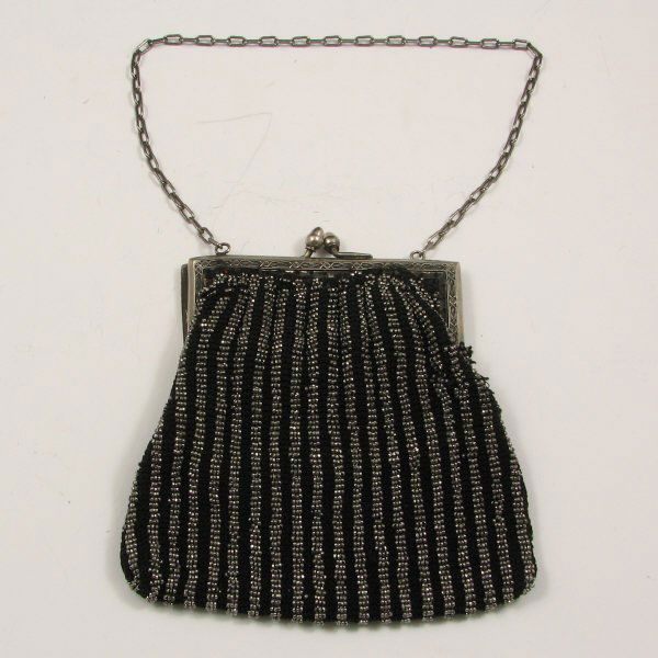 Antique German Silver Beaded Handbag : Antique German silver beaded handbag with black and metallic beads and an Art Deco frame. Unmarked. fair condition with some separation from the frame and subsequent repair attempt with a wire. Bag me