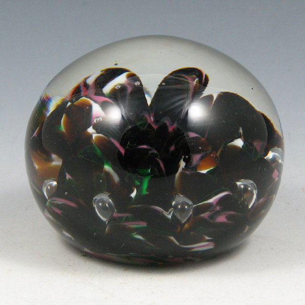 St. Clair (Maude and Bob) 1978 Colored Paperweight: Maude and Bob St. Clair multi-colored paperweight with dark tones of pink, green, amber and white from 1978. Marked with impressed circular mark. Excellent condition. 3" wide by 2 3/8" tall.