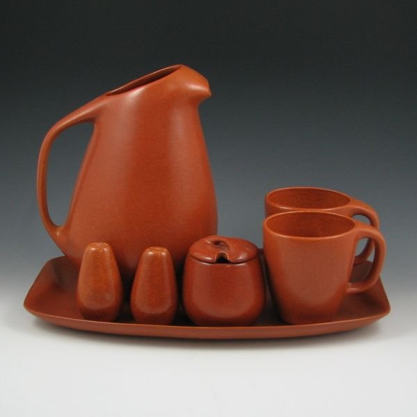 Roseville Raymor Snack & Serving Pieces (Eleven): Eleven (11) terra cotta Roseville Raymor snack and serving pieces including four (4) #152 dinner plates, #189 ice-lip water pitcher, salt and pepper shakers, two (2) #179 cups, a #172 lidded condiment