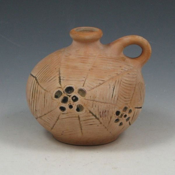 Weller Jug w/ Spider Webs - Excellent: Weller jug with stylized spider webs. The finish is a buff bisque finish on a terra cotta body similar to in a finish Burntwood or Souevo. Unmarked. Excellent condition. 4 1/4" tall by 4 3/4" wide.