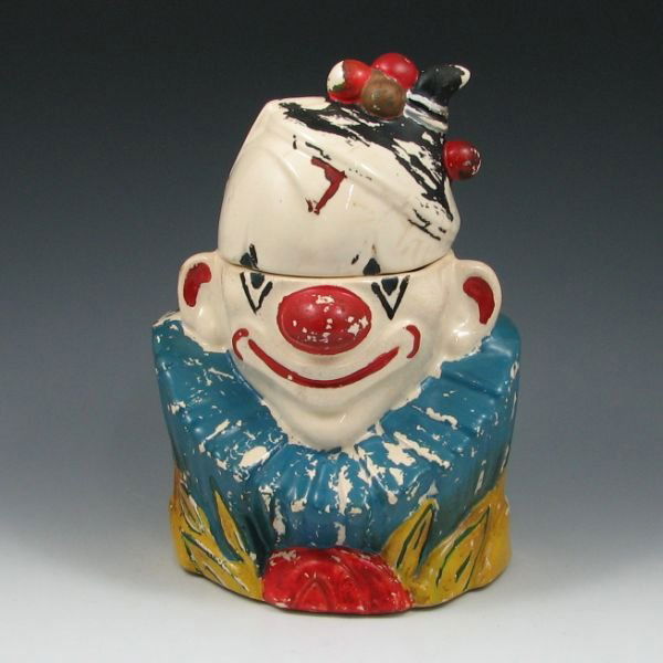McCoy #19 Clown Bust Cookie Jar: McCoy #19 Clown Bust cookie jar. Marked McCoy. There is wear/loss to the cold-painted decoration some stained crazing. Otherwise, no overt damage such as chips or cracks. 10 3/8" tall.