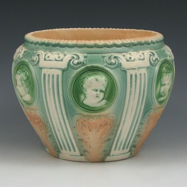 Roseville Cherub Cameo 584-6" Jardiniere: Roseville Cherub Cameo 584-6" jardiniere. Unmarked. There is a minute glaze nick to the edge of the rim, which appears to be a factory flaw. 8" wide by 5 7/8" tall. Provenance: Gordon & Sue Hoppe Coll