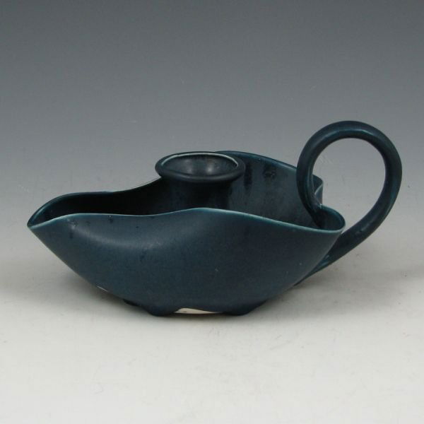 Hampshire Matte Blue Candleholder or Chamberstick: Hampshire Pottery Arts & Crafts candleholder or chamberstick in matte blue. Marked Hampshire Pottery 31 with circle M. There are some glaze misses to the underside of the piece. A tight hairline is vi
