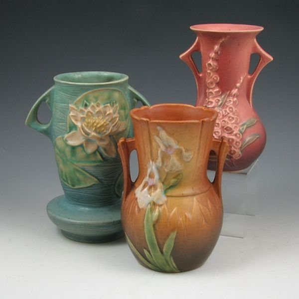 Roseville Foxglove, Iris & Water Lily Vases: Roseville Foxglove 43-6" vase (tight line to rim), Iris 917-6" vase (discolored) and Water Lily 75-7" vase (flake to base foot). All marked. 6 1/8" to 7 1/8" tall.