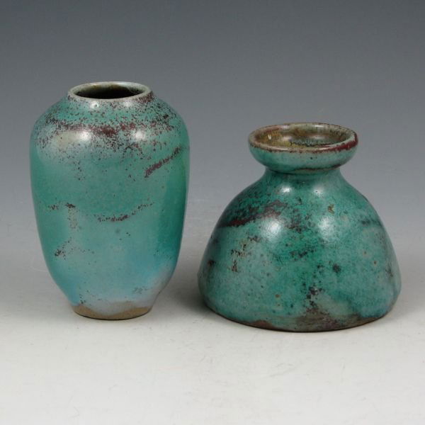 Ben Owen Jugtown Ware Chinese Blue Vases (2): Two Ben Owen Jugtown Ware vases in Chinese Blue over red glazes. Marked Jugtown Ware. The taller vase has a minute 1/16" nick to the rim while the other has two very tight hairlines to its rim. 3 3/4"