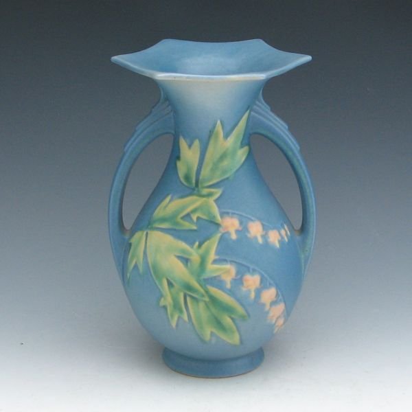 Roseville Bleeding Heart 971-9" Vase - Mint: Roseville Bleeding Heart vase in blue. Marked Roseville USA 971-9". Mint. 9 3/8" tall.Provenance: Collection Museo de Arte de Ponce, Puerto Rico.