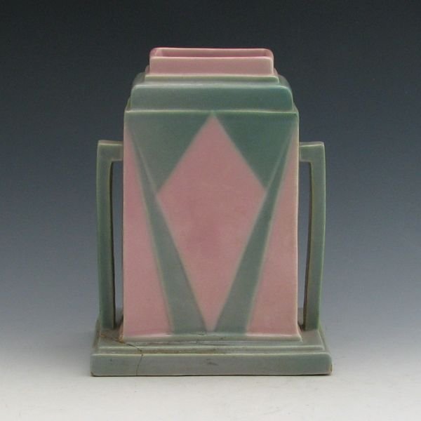 Roseville Futura 386-8" Jukebox Vase w/ Label: Roseville Futura 386-8" Jukebox vase. Marked with black paper label. A bottom of the corner has been broken off and glued back in place and there is a chip to the opposite corner. 8 1/8" tall.Provenan