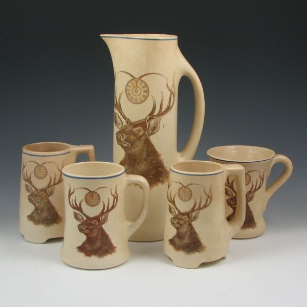 Roseville Creamware Elks Tankard & Mugs Set: Roseville Creamware Elks tankard set with four mugs, each of a different shape. All unmarked. All are in typical used condition with wear to the appliques and darkened crazing. The tankard has a bruis