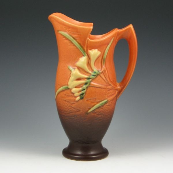 Roseville Freesia 20-10" Ewer - Mint: Roseville Freesia ewer in brown. Marked Roseville USA 20-10". Mint. 10 1/2" tall. Provenance: Gordon & Sue Hoppe Collection.