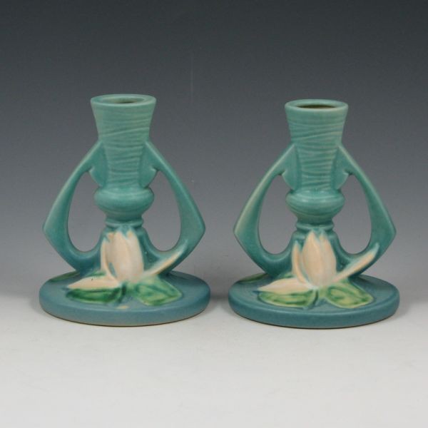 Roseville Water Lily Candlesticks - Mint: Roseville Water Lily candlesticks in blue. Marked Roseville USA 1155-4 1/2". Mint. 4 5/8" tall. Provenance: Gordon & Sue Hoppe Collection.