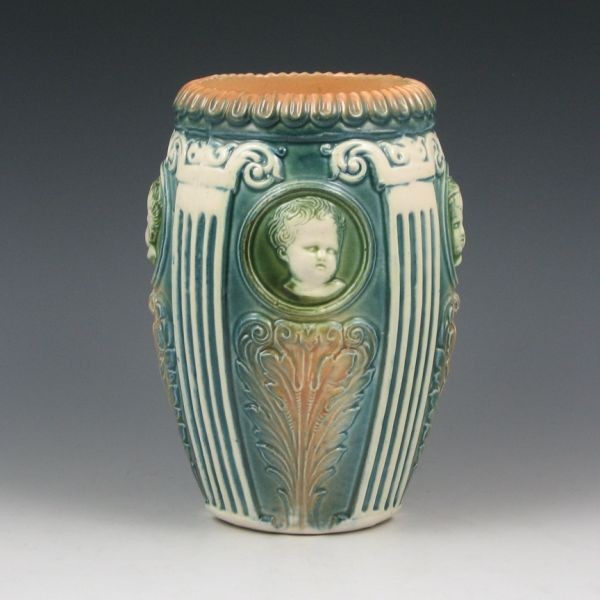 Roseville Cherub Cameo 7 1/2" Vase: Roseville Cherub Cameo vase. Unmarked. A tight hairline, which is more visible on the interior than the exterior, descends from the rim. 7 1/2" tall. Provenance: Gordon & Sue Hoppe Collection.