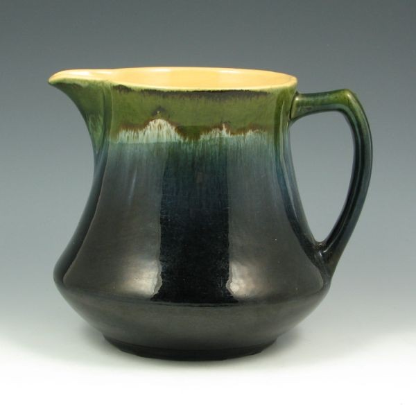 Roseville Early Utility Blended Glaze Pitcher: Roseville early utility blended glaze pitcher. Unmarked. There is crazing and some wear to the glaze from use, but no overt damage or repairs. 7" tall. Provenance: Gordon & Sue Hoppe Collection.