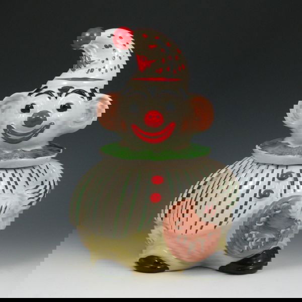 Regal Clown Cookie Jar: Regal clown cookie jar. Marked Translucent Vitrified China Copyright Miller 54-439A. There is a faint hairline descending from the rim of the jar and some loss to the cold paint. 11 1/2" tall.