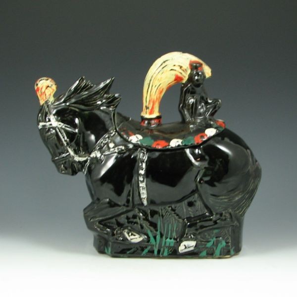 McCoy Circus Horse Cookie Jar: McCoy circus horse cookie jar in black. Marked McCoy USA. Chip to horse's mane and loss of cold paint. 9 1/2" tall.