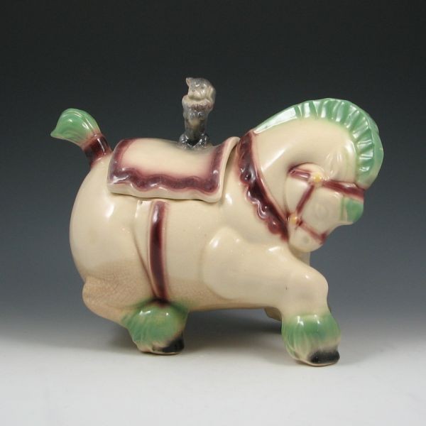 Brush Circus Horse Cookie Jar: Brush circus horse cookie jar. Unmarked. Factory flaws to tail (glaze skips, factory chip) and darkened crazing to lower portion of the jar. 9 1/4" tall by 11 1/2" long.