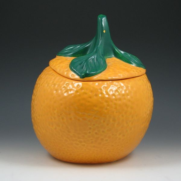 McCoy Orange Cookie Jar: McCoy orange cookie jar. Marked 257 McCoy USA. There is a flake of missing green cold paint on the stem, otherwise excellent. 11 1/2" tall.